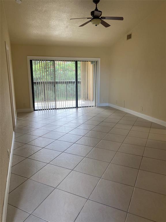 5701 Riverside Drive, Unit 302 Coral Springs, FL 33067 - Photo 7 of 21 a view of an empty room with a window