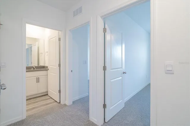 a view of a hallway with bathroom