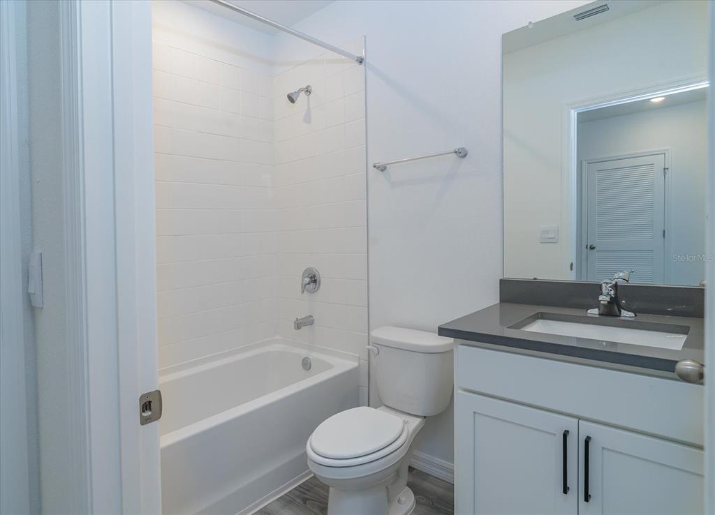 2466 Riversong Ldg Lane Wesley Chapel, FL 33543 - Photo 19 of 33 a bathroom with a sink toilet vanity and shower