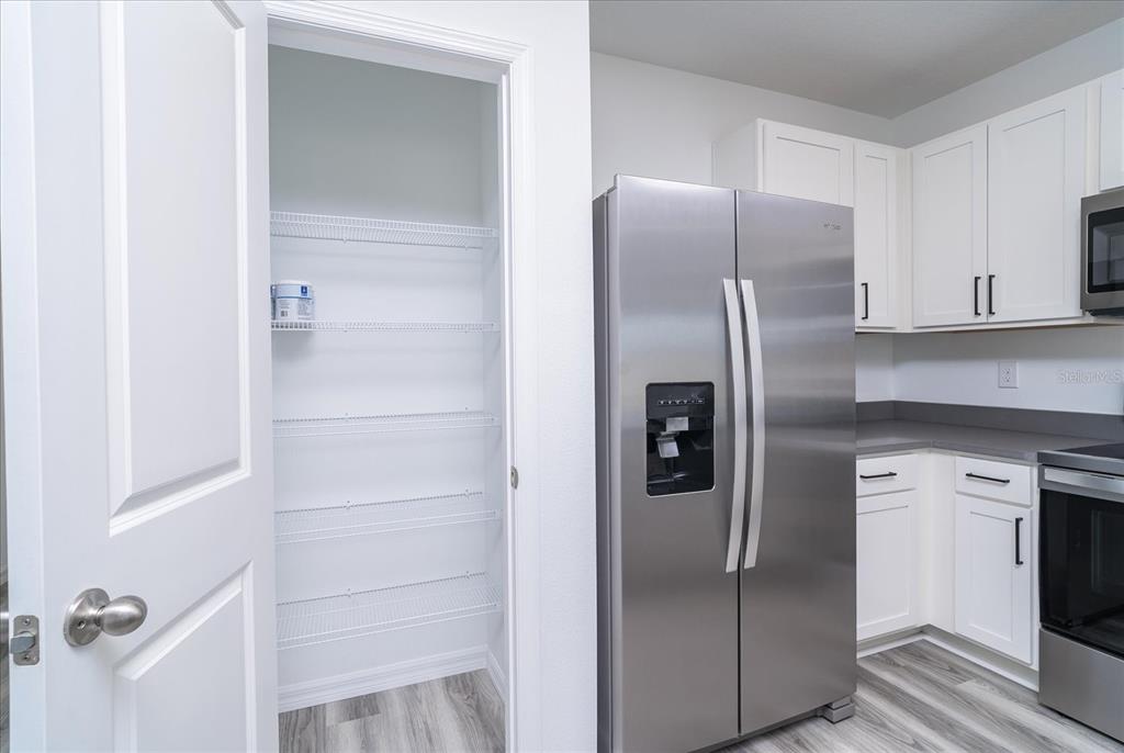 2466 Riversong Ldg Lane Wesley Chapel, FL 33543 - Photo 6 of 33 a metallic refrigerator freezer sitting in a kitchen