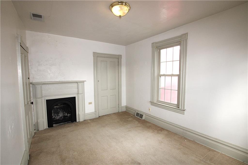 259 Mercer Street Harmony, PA 16037 - Photo 15 of 19 an empty room with windows and fireplace