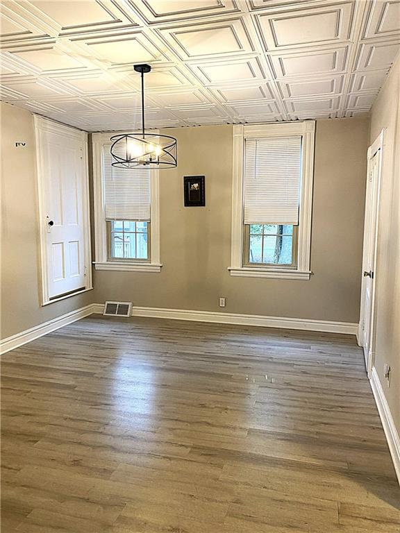 259 Mercer Street Harmony, PA 16037 - Photo 7 of 19 a view of an empty room with wooden floor and a window