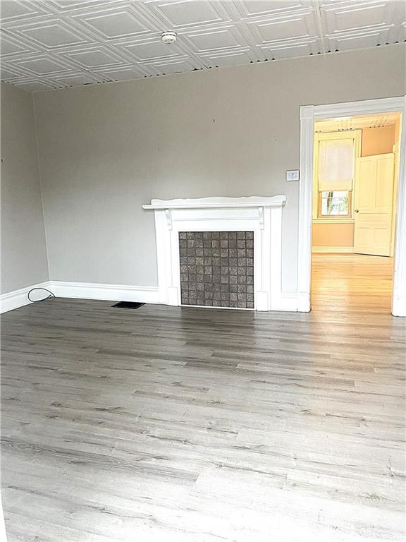 259 Mercer Street Harmony, PA 16037 - Photo 8 of 19 a view of empty room with window and wooden floor