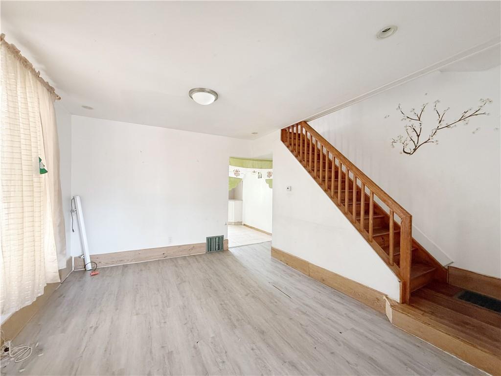 133 Quentin Road Brooklyn, NY 11223 - Photo 6 of 12 a view of an entryway with wooden floor