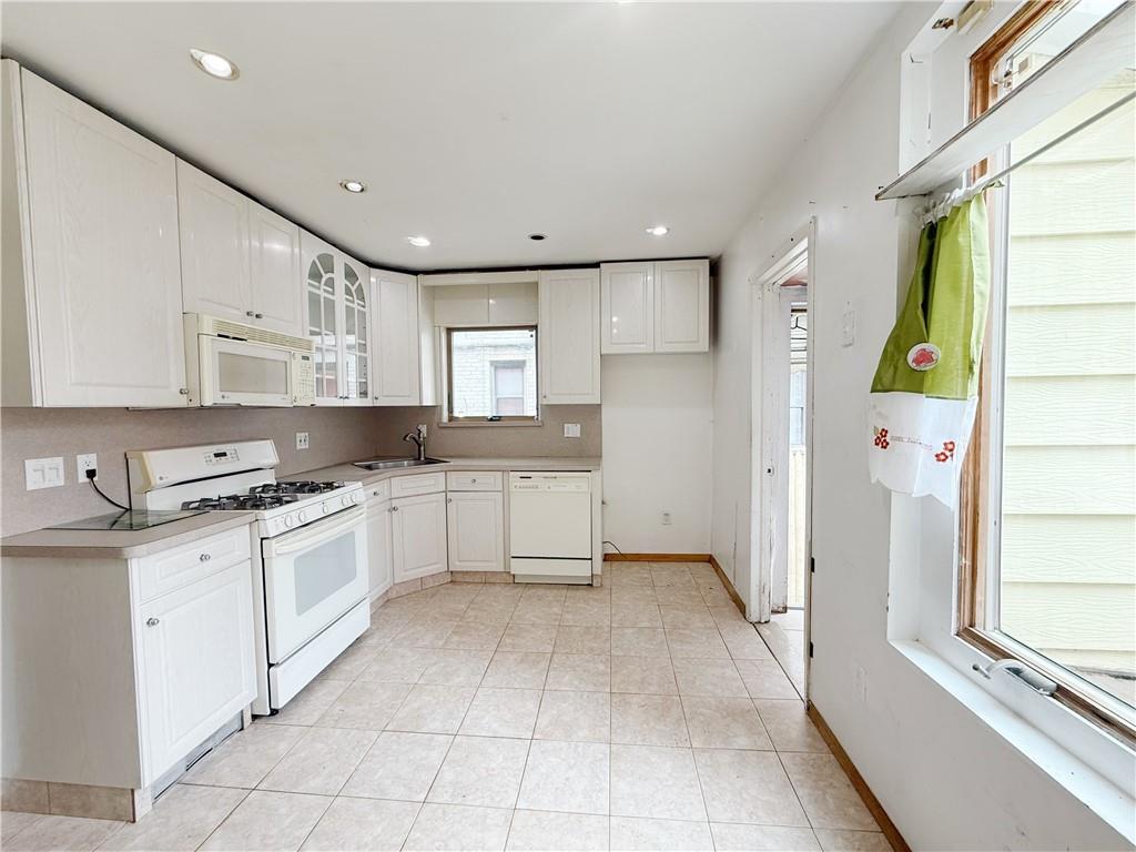 133 Quentin Road Brooklyn, NY 11223 - Photo 7 of 12 a kitchen with stainless steel appliances granite countertop a refrigerator and a stove top oven