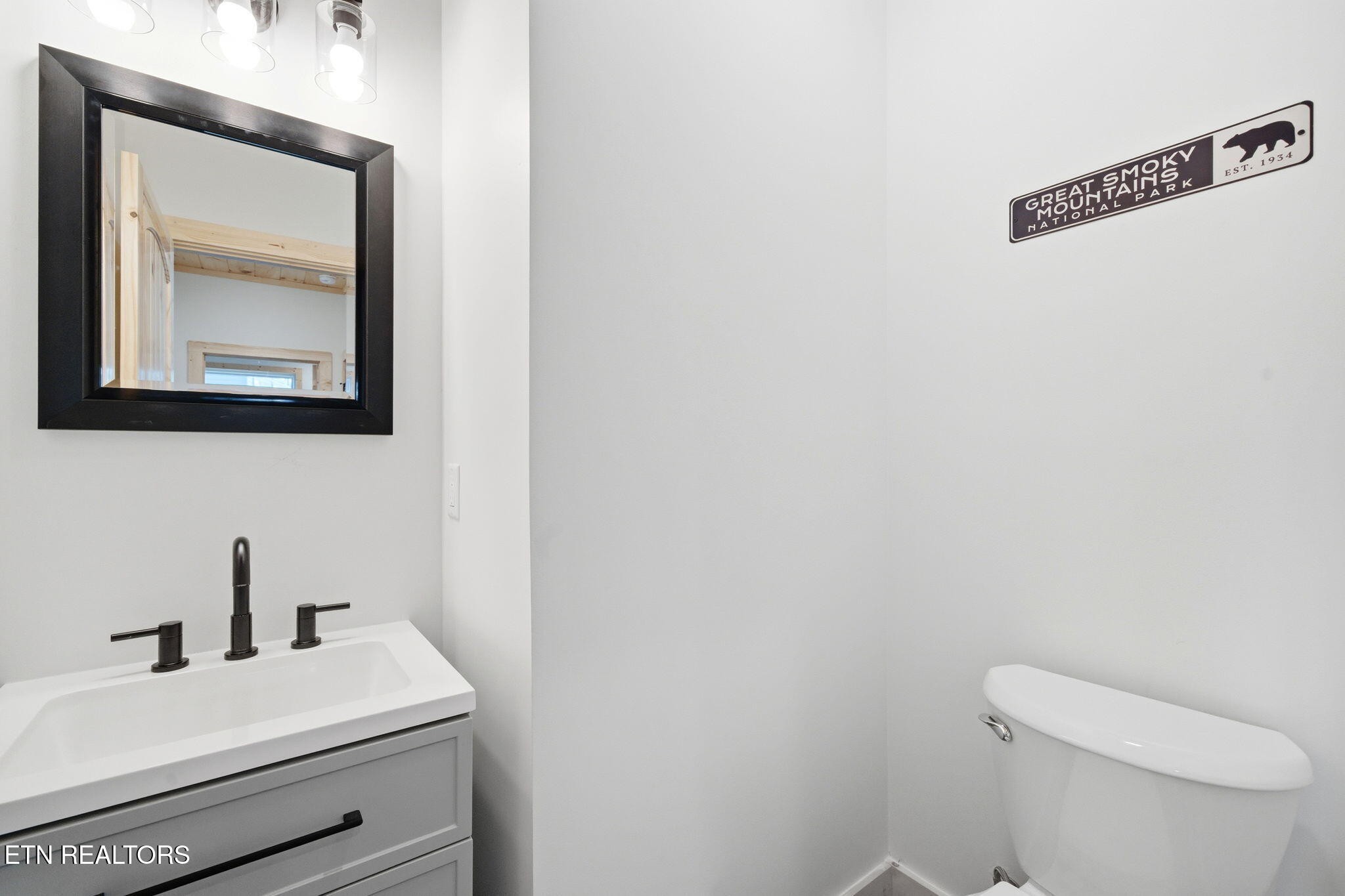 650 Ridge Top Loop Gatlinburg, TN 37738 - Photo 14 of 38 a bathroom with a toilet a sink and mirror