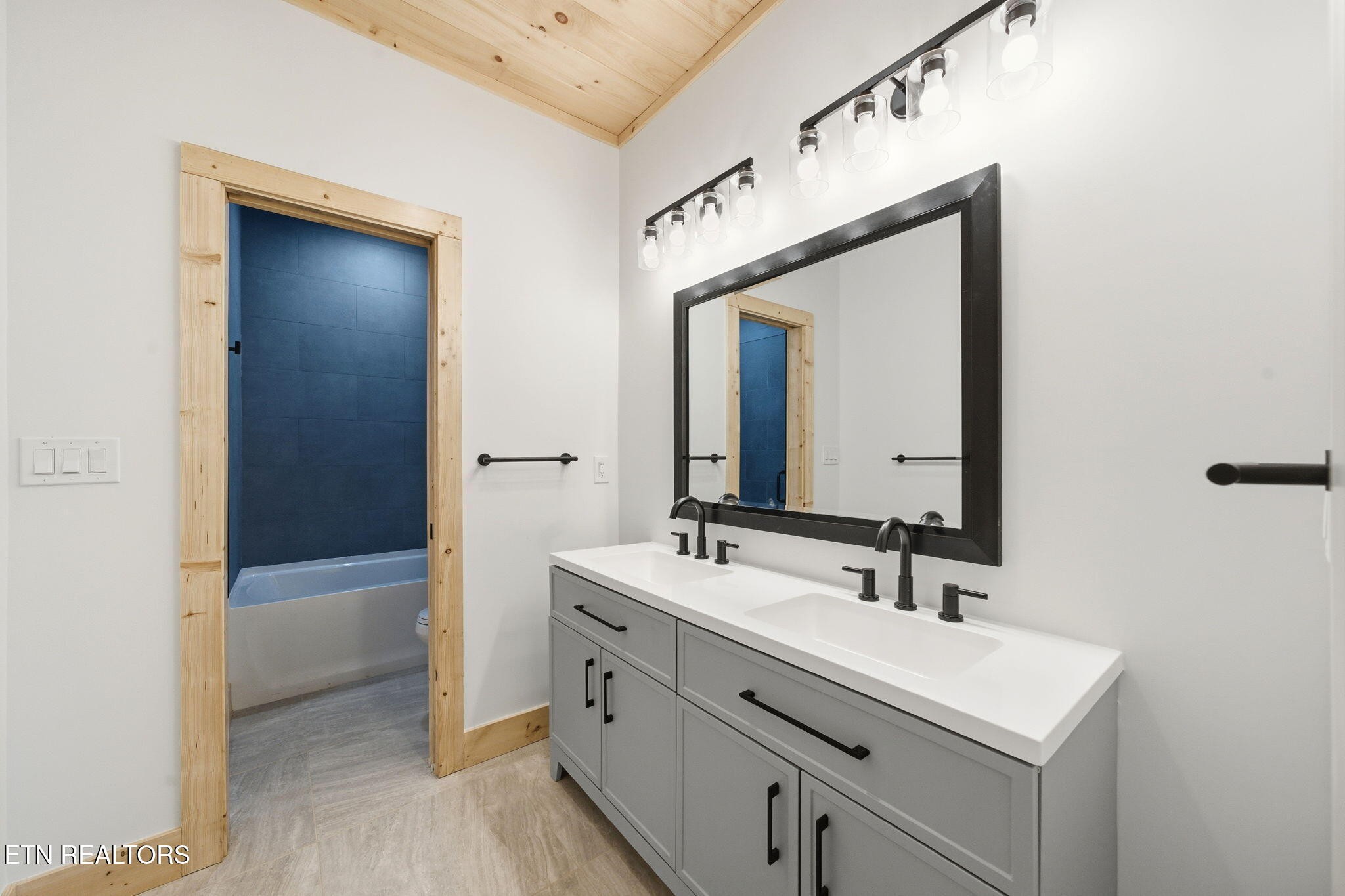 650 Ridge Top Loop Gatlinburg, TN 37738 - Photo 26 of 38 a bathroom with a sink a vanity and a mirror