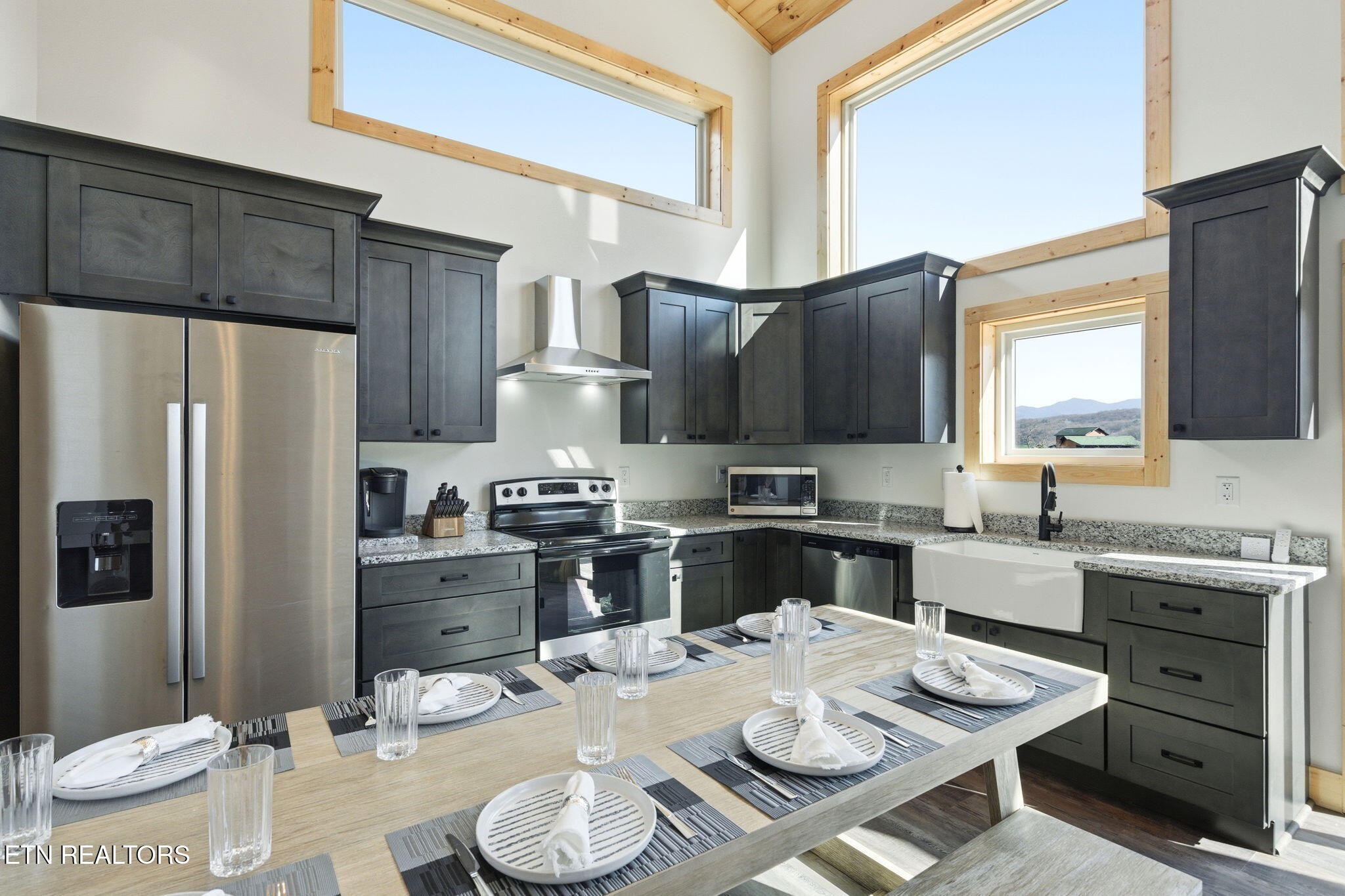 650 Ridge Top Loop Gatlinburg, TN 37738 - Photo 9 of 38 a kitchen with a appliances a stove a table and chairs in it