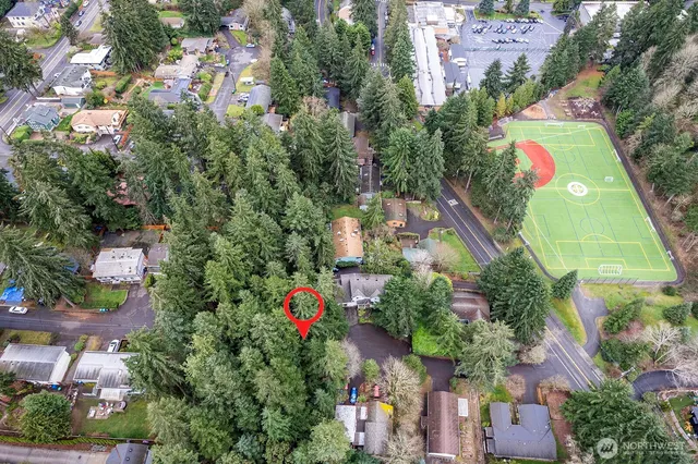 an aerial view of a houses with yard