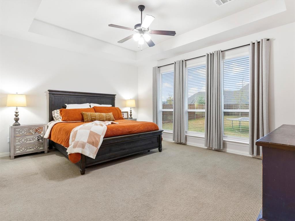2156 Cloverfern Way Haslet, TX 76052 - Photo 19 of 40 a bed sitting in a spacious bedroom next to a window