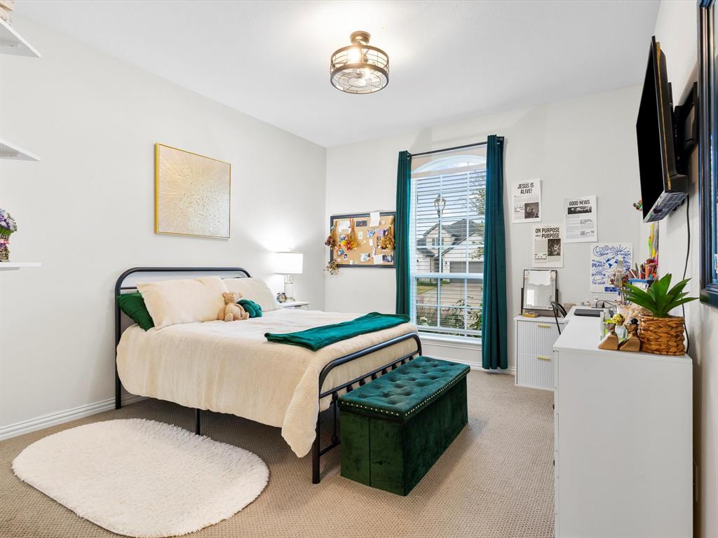 2156 Cloverfern Way Haslet, TX 76052 - Photo 26 of 40 a bedroom with a bed and a flat screen tv