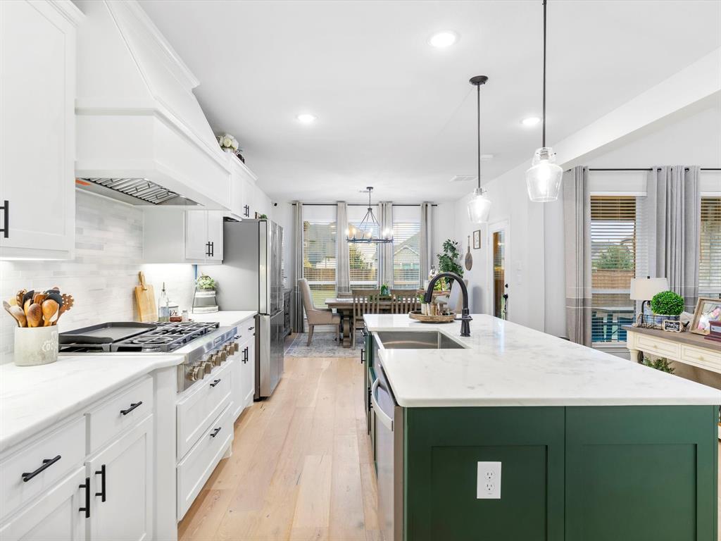 2156 Cloverfern Way Haslet, TX 76052 - Photo 8 of 40 a kitchen with kitchen island a sink stove and refrigerator