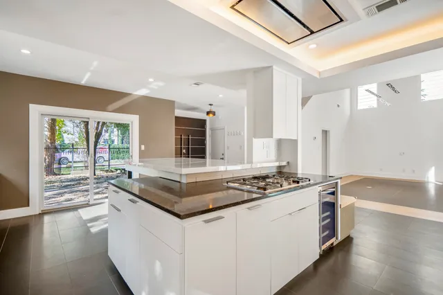 a kitchen with stainless steel appliances granite countertop a stove a sink and a refrigerator