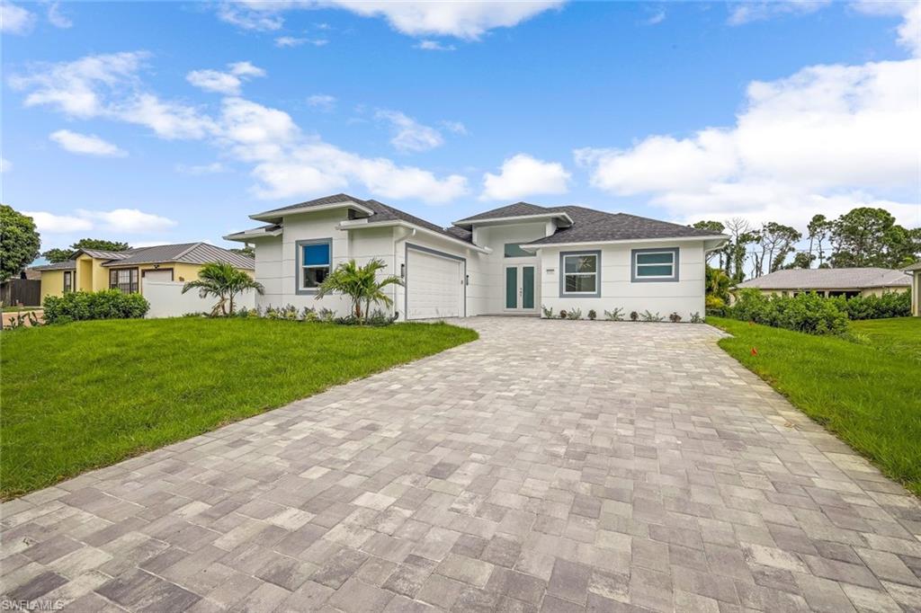9107 Henry Road Fort Myers, FL 33967 - Photo 1 of 26 a front view of a house with a yard