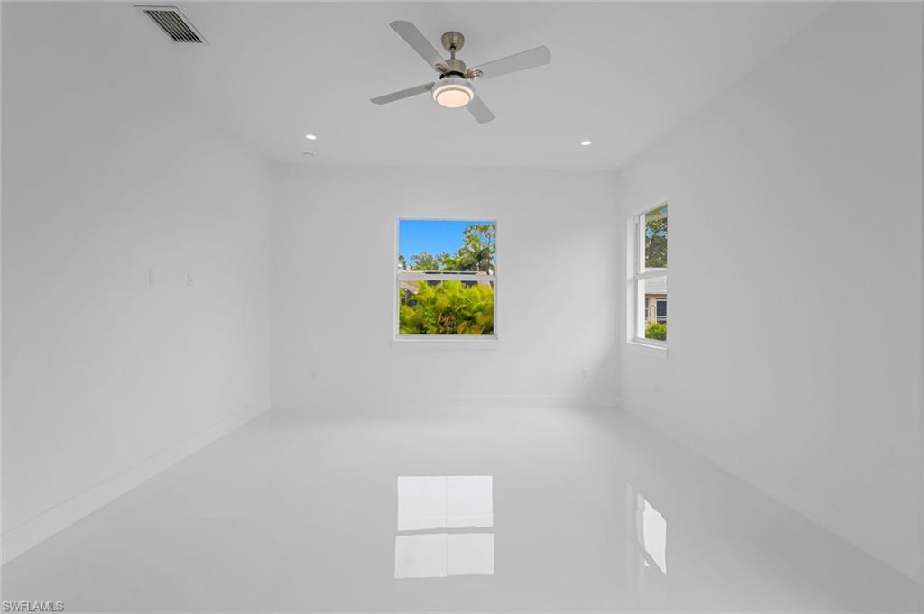 9107 Henry Road Fort Myers, FL 33967 - Photo 13 of 26 an empty room with windows and ceiling fan