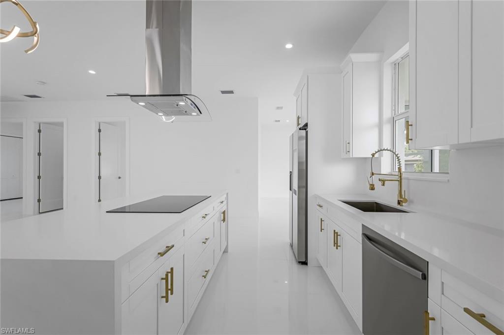 9107 Henry Road Fort Myers, FL 33967 - Photo 6 of 26 a kitchen with a sink stove and refrigerator