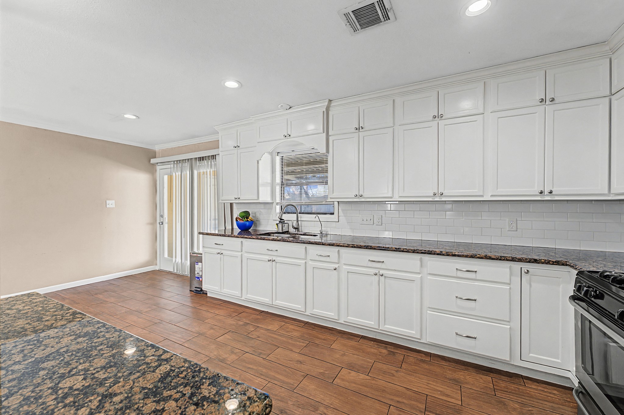 823 Marleen Street Houston, TX 77034 - Photo 6 of 15 a kitchen with granite countertop white cabinets and white appliances