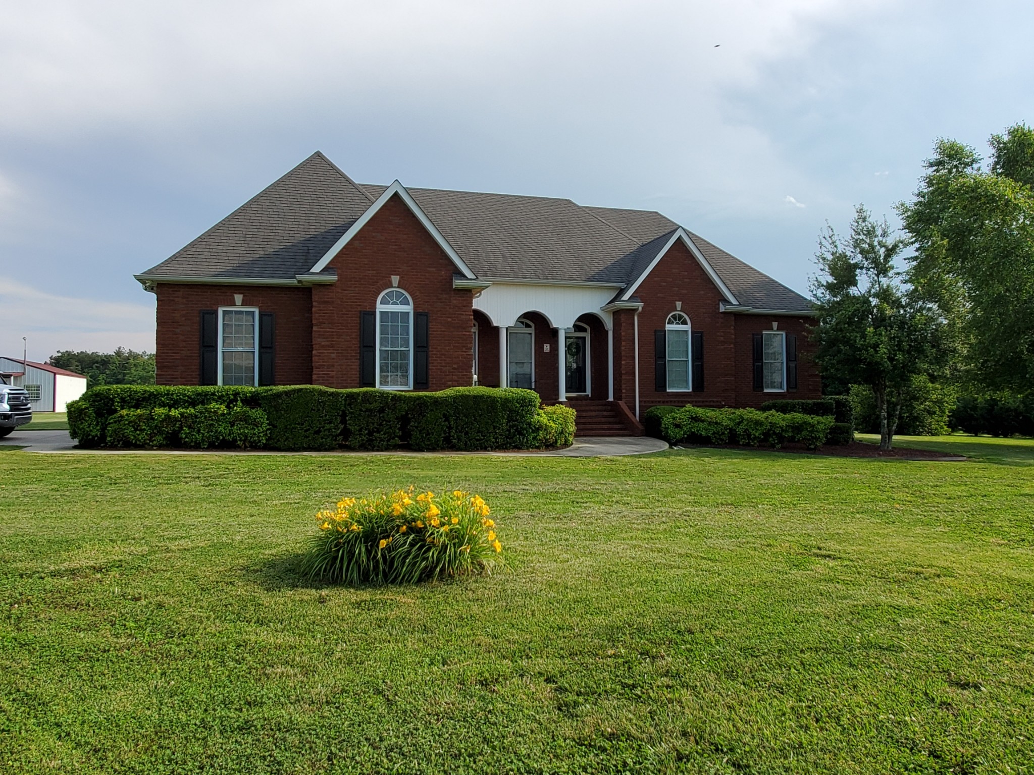 2707 Sixteenth Model Road Manchester, TN 37355 - Photo 2 of 50 a front view of a house with a yard and garage