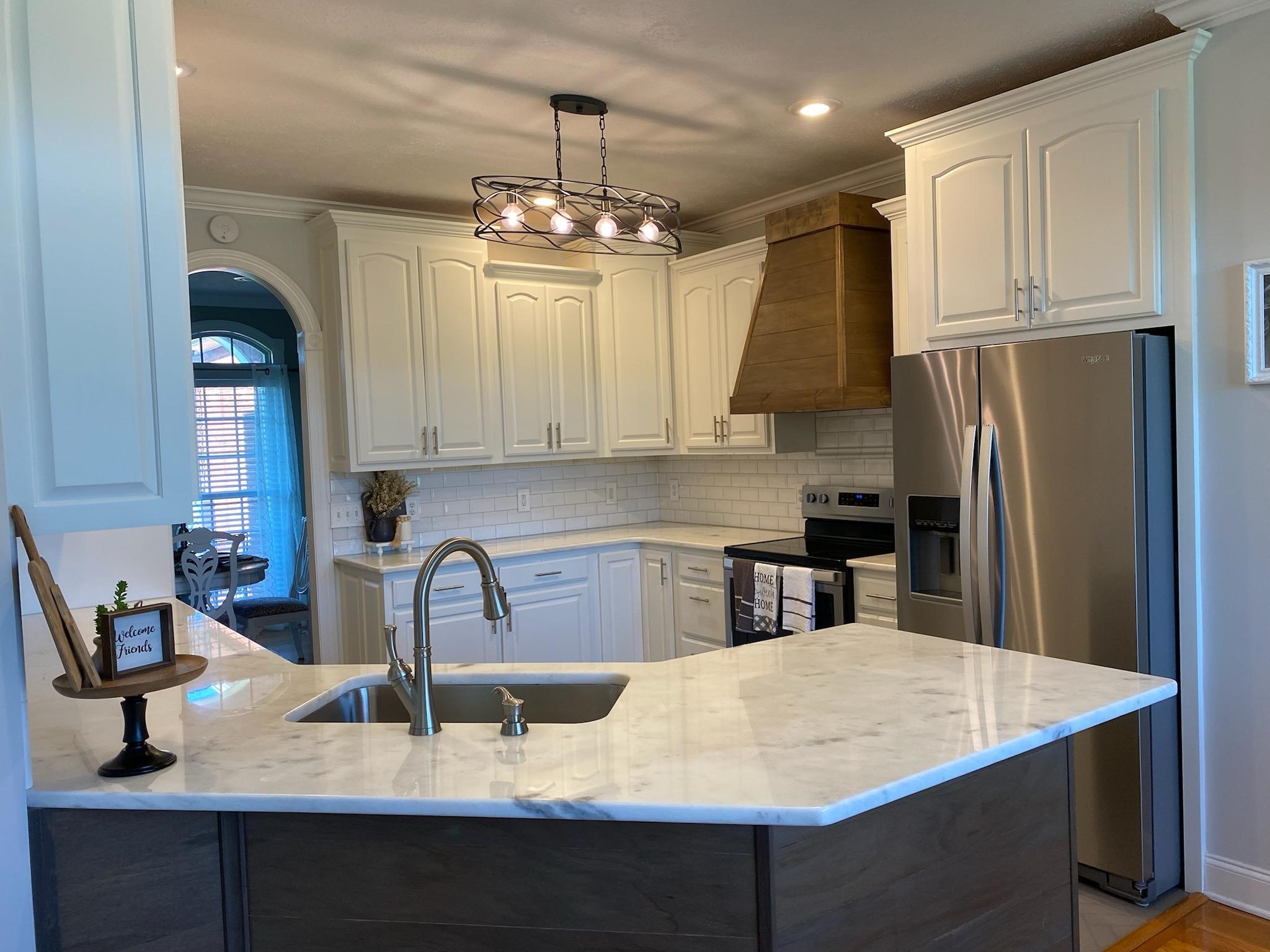 2707 Sixteenth Model Road Manchester, TN 37355 - Photo 12 of 50 a kitchen with stainless steel appliances granite countertop a sink refrigerator and cabinets