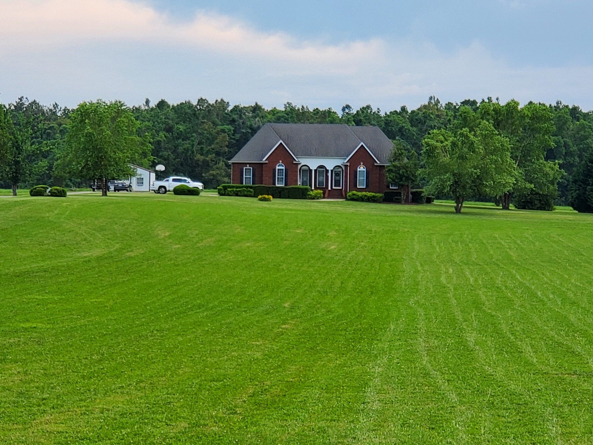2707 Sixteenth Model Road Manchester, TN 37355 - Photo 47 of 50 a view of a big house with a big yard and large trees