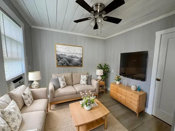 a living room with furniture and a flat screen tv