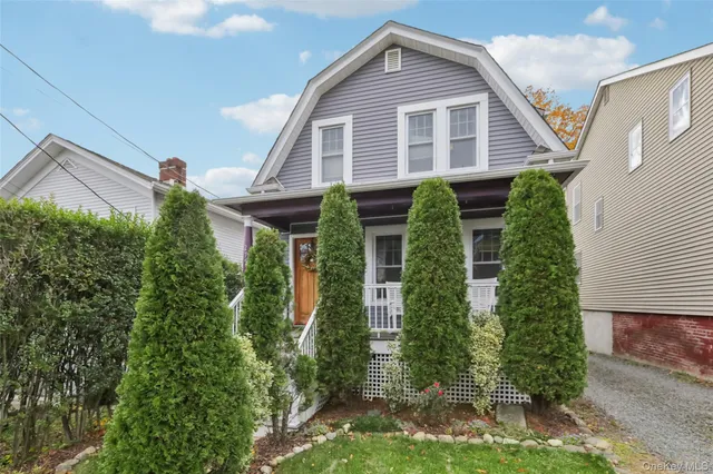 a view of a house with brick walls and plants