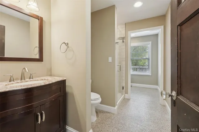 a bathroom with a granite countertop sink toilet and shower