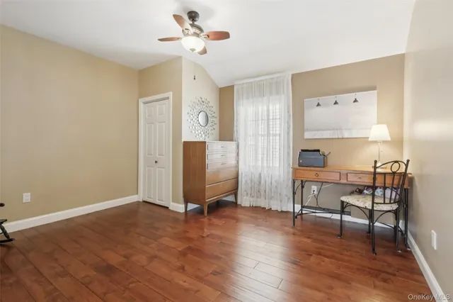 a view of a workspace with furniture and wooden floor