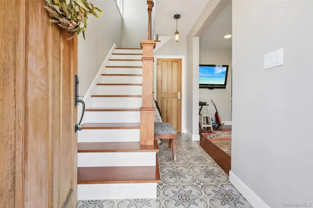 a view of entryway and hall with wooden floor