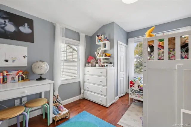 a room with furniture a baby crib and a window