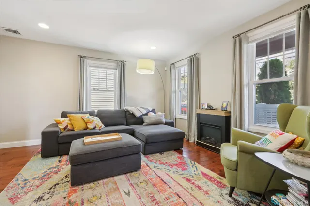 a living room with furniture a rug and a window