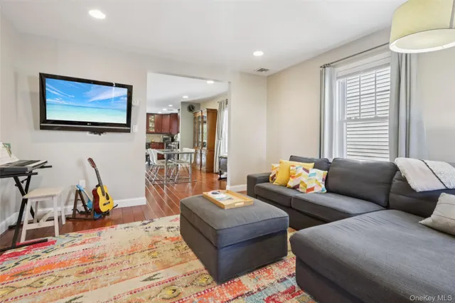 a living room with furniture a air conditioner vent and a window