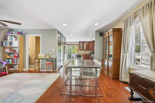 a view of a living room with furniture and floor to ceiling window