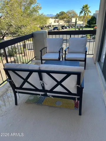 a view of a balcony with chairs