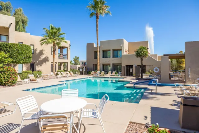 a bathroom with a granite countertop sink a toilet and a mirror