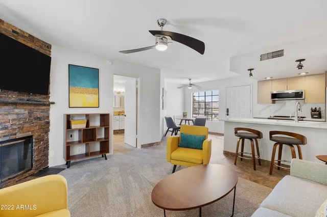 a living room with fireplace furniture and a flat screen tv