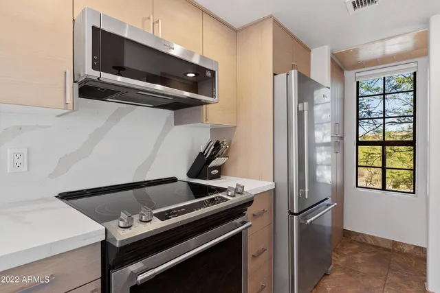 a living room with furniture a rug and a chandelier