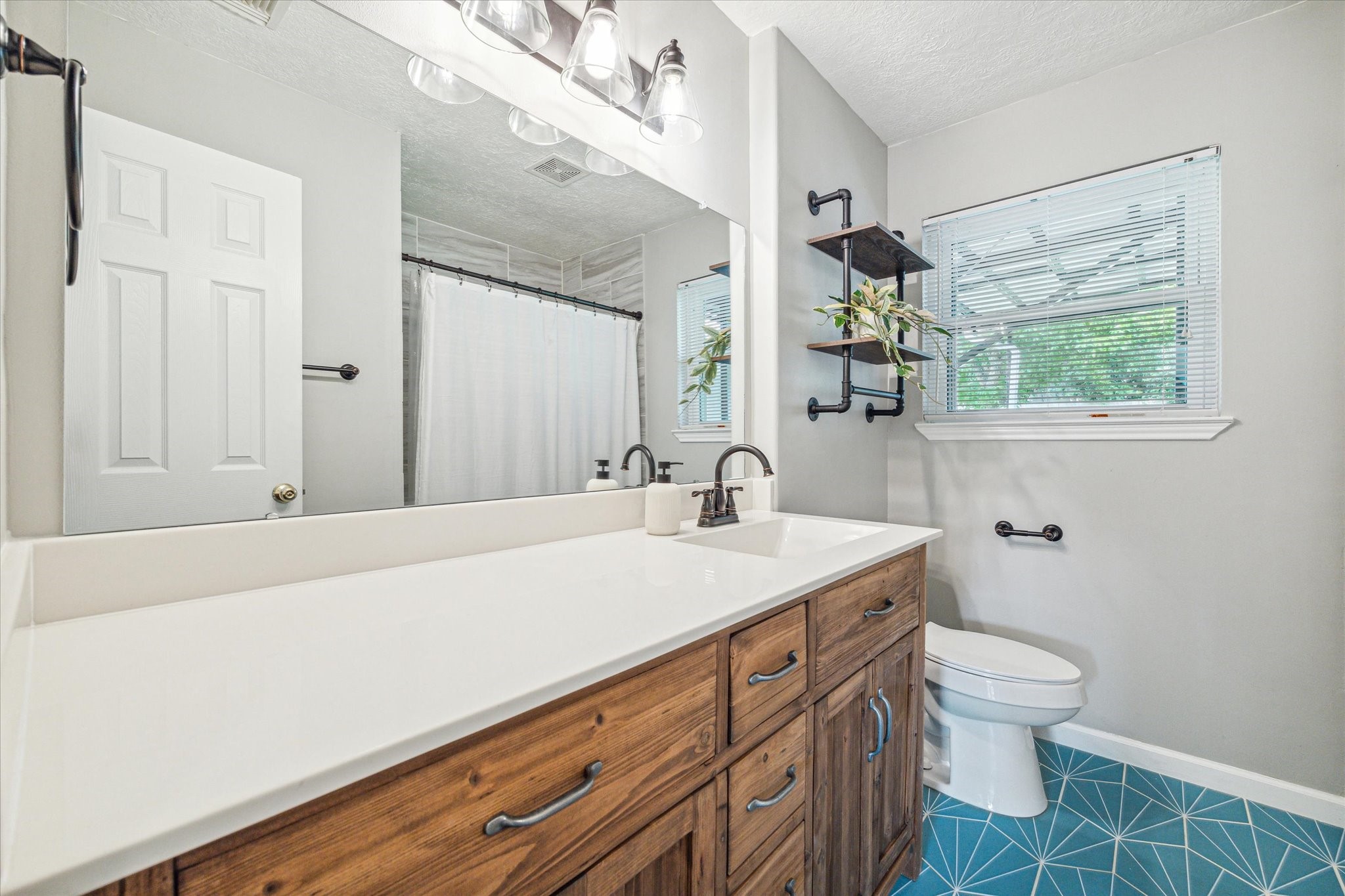 3613 Lazy Spring Drive Houston, TX 77080 - Photo 13 of 22 a bathroom with a sink a toilet and mirror