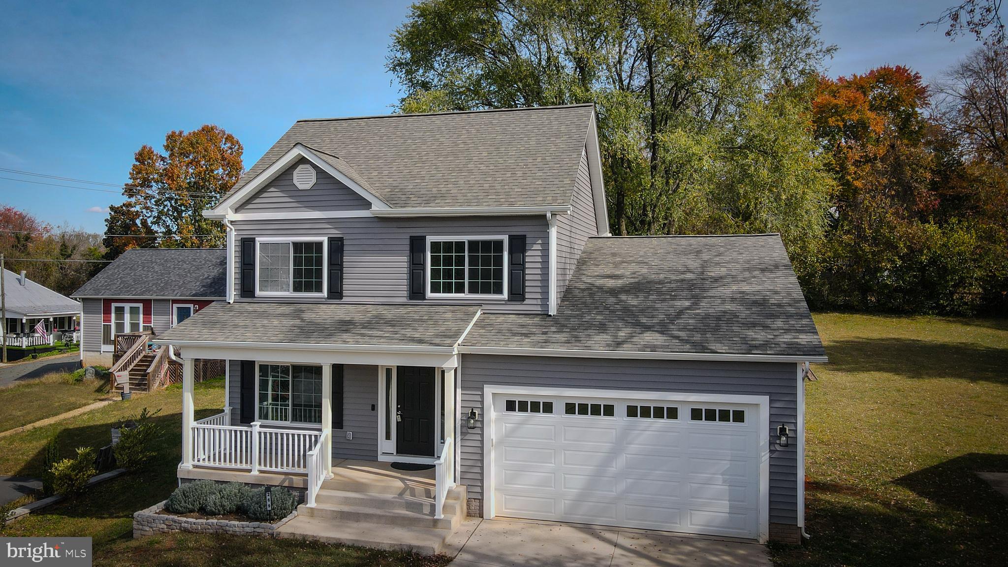 a front view of a house with a garden and plants