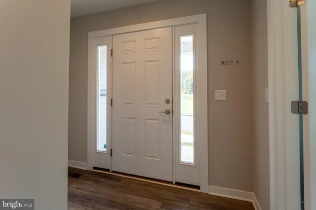 a large kitchen with stainless steel appliances granite countertop a large stove a sink dishwasher and a refrigerator with wooden floor