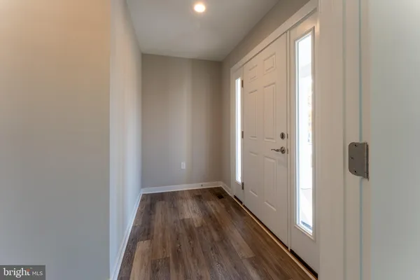 a bathroom with a granite countertop toilet and sink