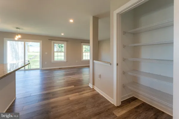 a view of a hallway with windows and closet