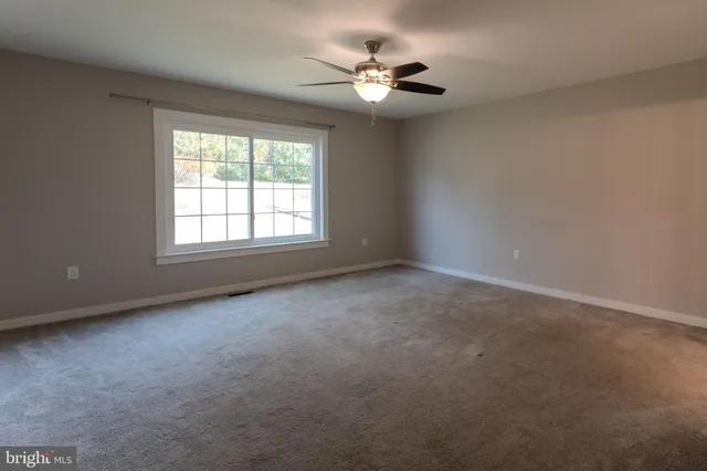 a bathroom with a granite countertop sink toilet a mirror and a shower