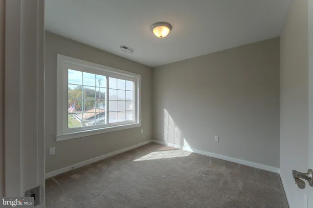 a front view of a house with a yard and lake view