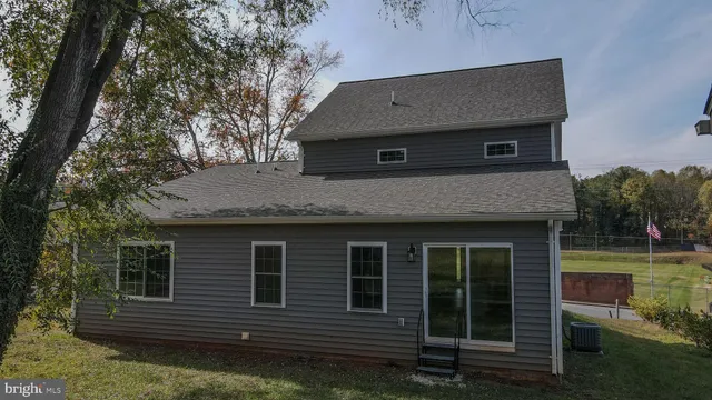 a kitchen with stainless steel appliances granite countertop a stove top oven a sink a microwave and cabinets