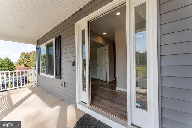 a large kitchen with stainless steel appliances granite countertop a large counter top a sink and a refrigerator