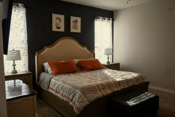 a bedroom with a bed and window