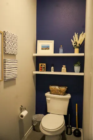 a white toilet sitting next to a bathroom sink