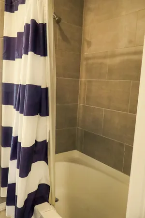 a bathroom with a bathtub and shower