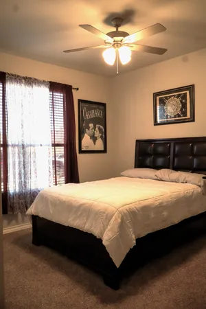a bedroom with a large bed and a window